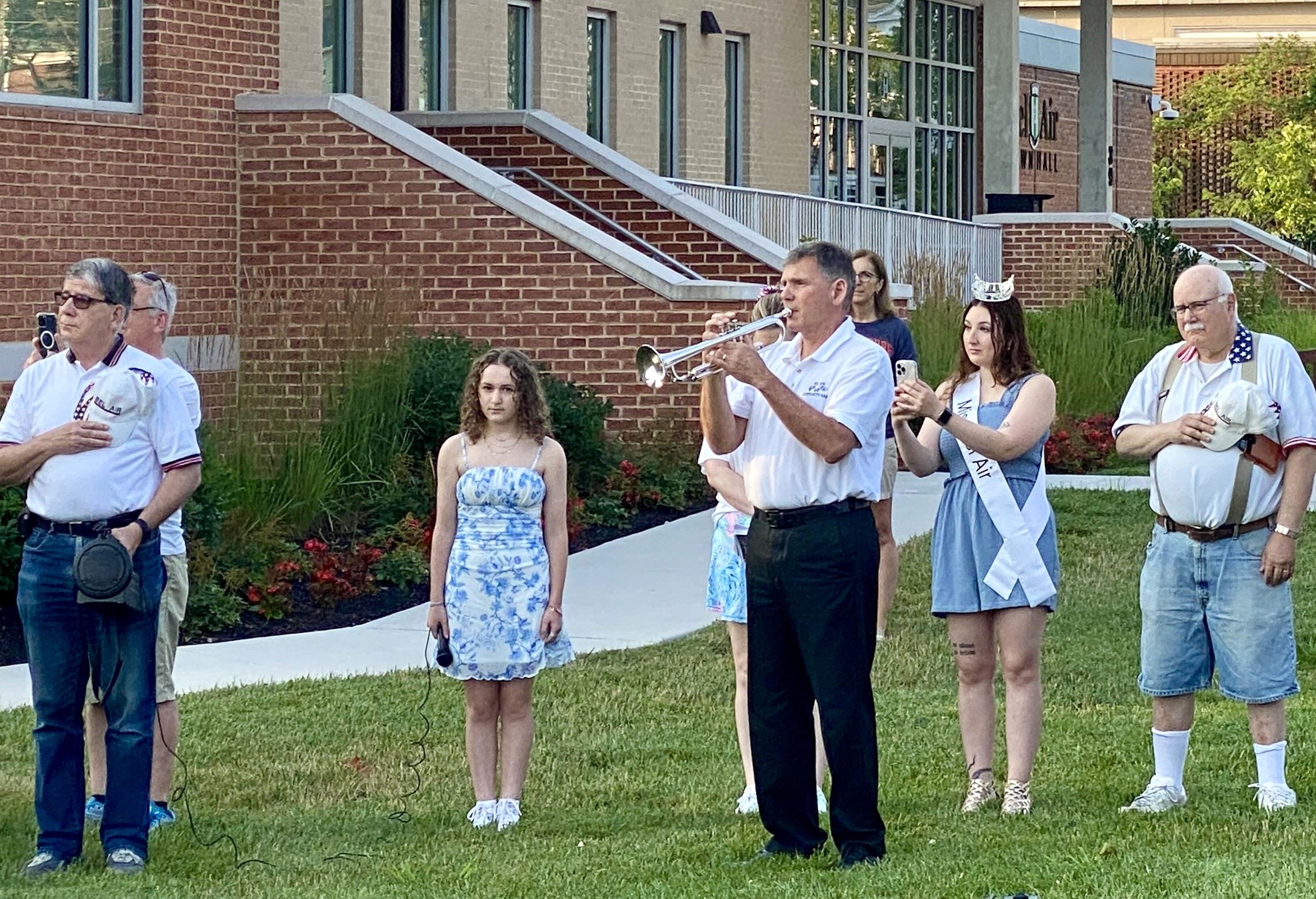 Photo of the bugle being played at an Independence Day flag-raising ceremony at Bel Air Town Hall