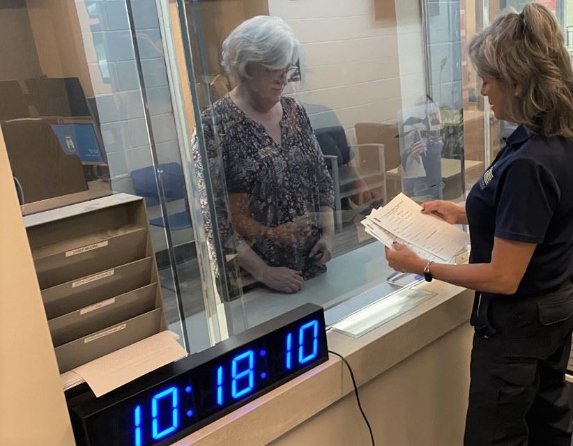 A photo of Bel Air Police PCO Karla Melchior at the dispatch center's customer service window.