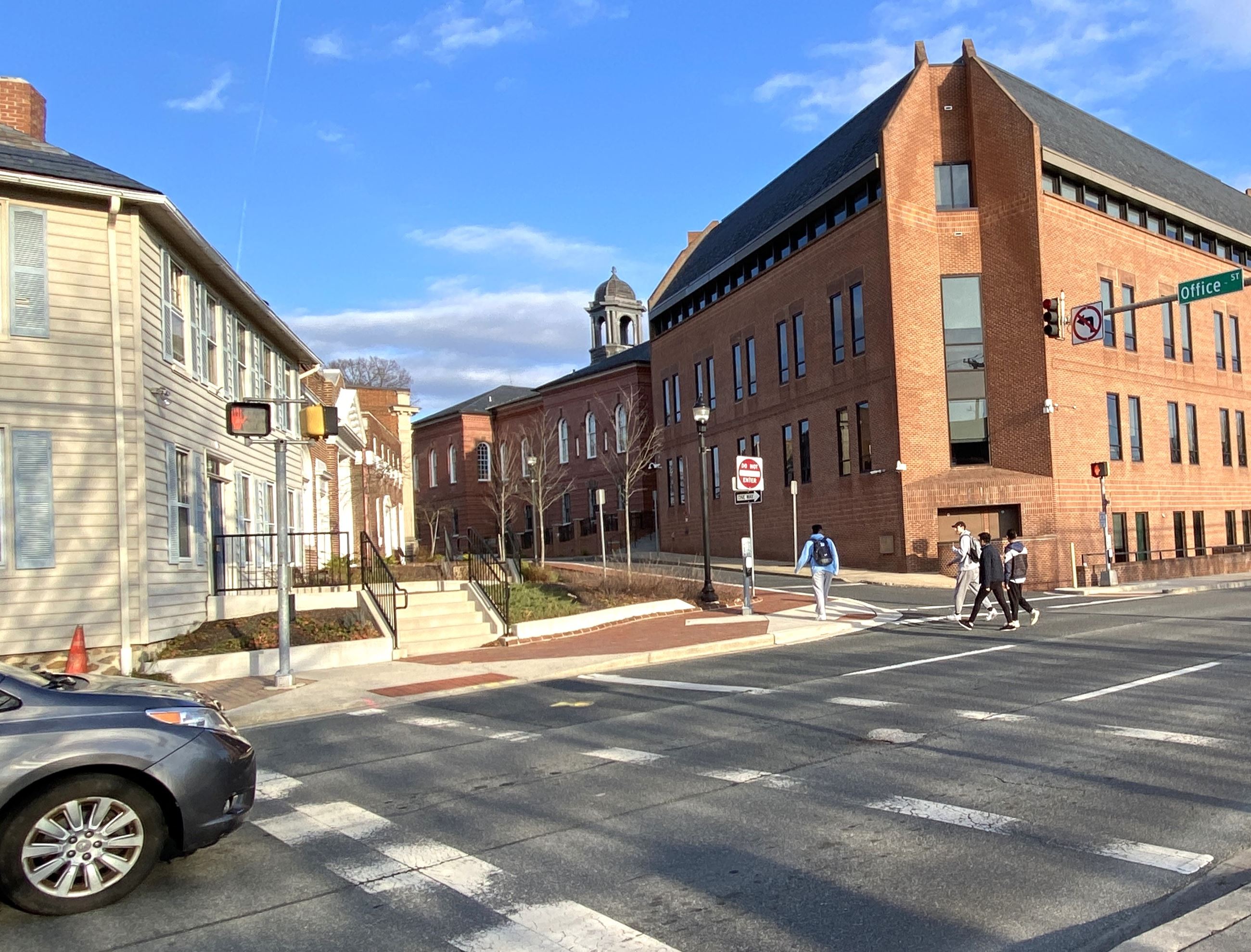 A photo of pedestrians crossing South Bond Street in Bel Air near the Harford County Courthouse